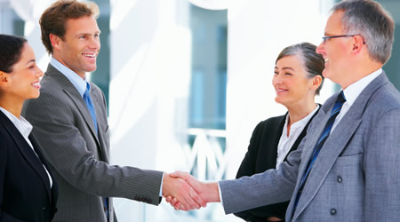 Picture of four people meeting and greeting 